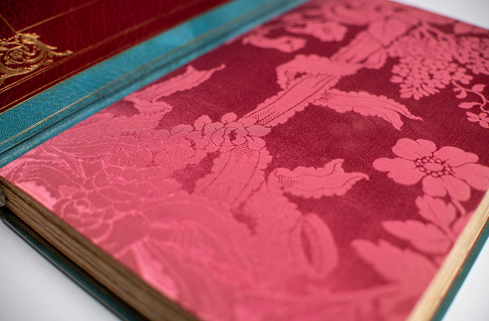 Close-up of a book’s red floral-patterned endpaper