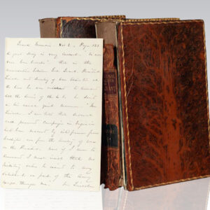 Old leather-bound books with handwritten letter.