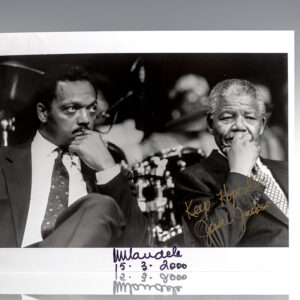 Black-and-white photograph of two men in suits seated side by side