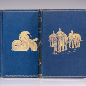 Two blue antique books with gold embossed snake and elephant designs