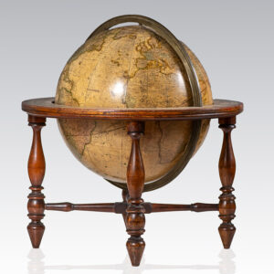 Antique terrestrial globe mounted on a wooden stand with four turned legs.