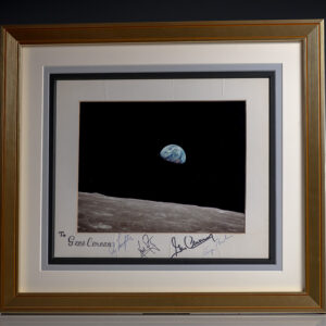 Framed photograph of Earth rising over the Moon’s horizon