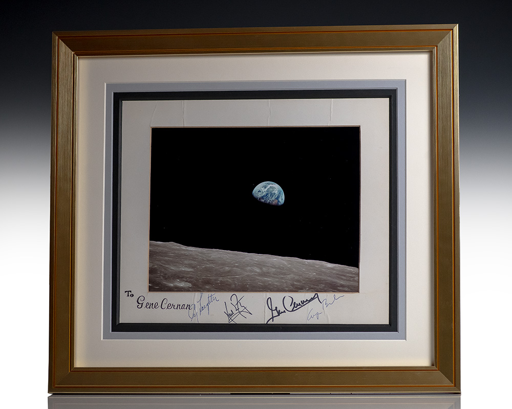 Framed photograph of Earth rising over the Moon’s horizon