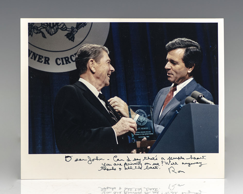 Rare photograph of Ronald Reagan receiving a Life Member Awards from the Republican Senatorial Inner Circle; inscribed by him
