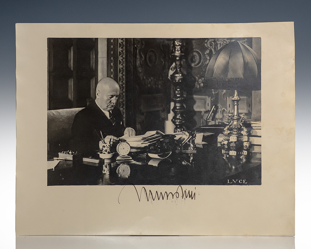 Photograph of a Man Sitting at an Ornate Desk