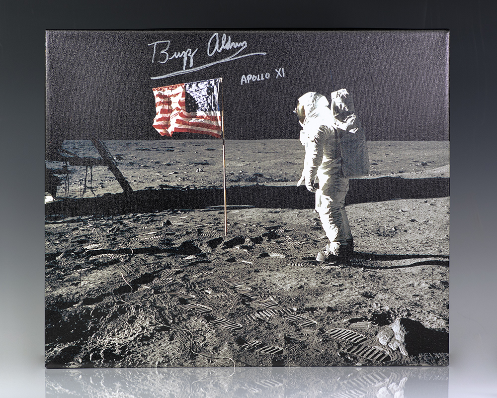 Iconic photograph on canvas of Buzz Aldrin standing next to the United States flag planted atop the lunar surface during the Apollo 11 mission. Boldly signed 
