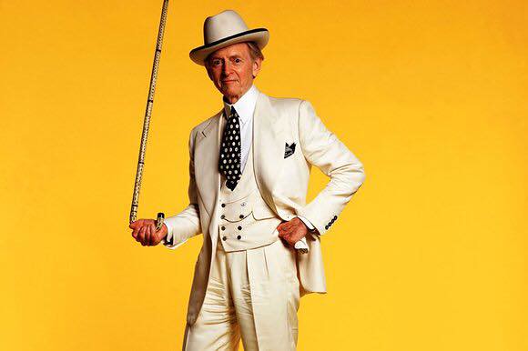 Tom Wolfe with yellow background. 