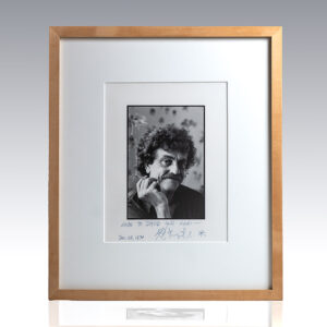 Framed black-and-white portrait of a man with curly hair